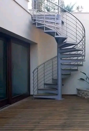 Steel spiral staircase leading to a first-floor patio