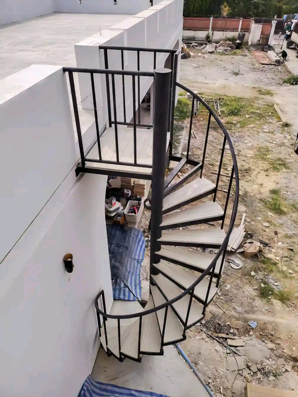 Steel spiral staircase being installed on site