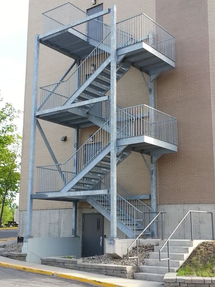 Galvanised switchback fire staircase across a building facade