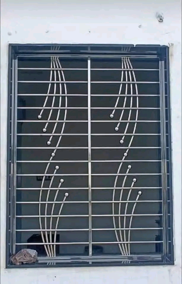 Decorative scrolled steel burglar bars on a bedroom window