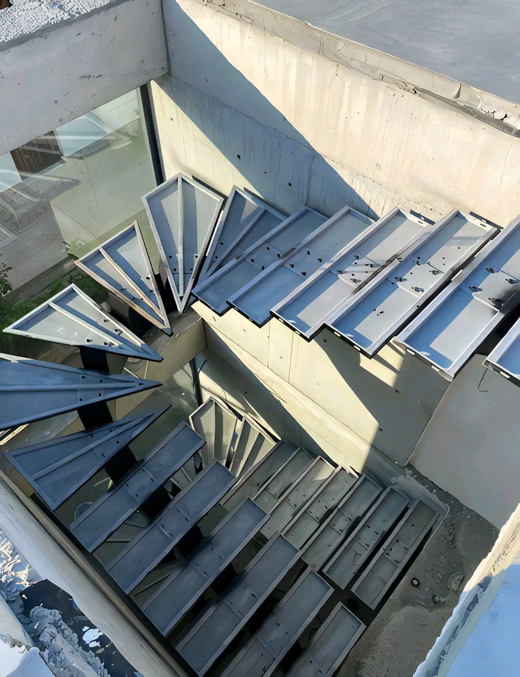 Steel spiral staircase photographed from above showing the tread fan