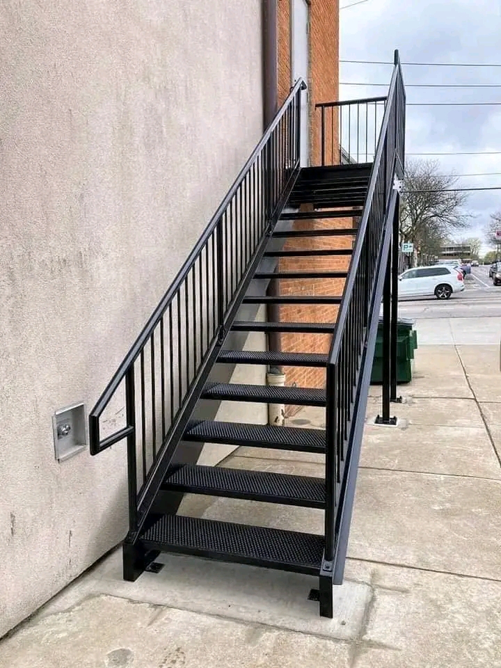 Straight black steel staircase with slim handrail